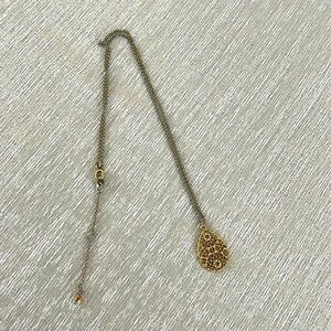 Gold pendant on silver chain